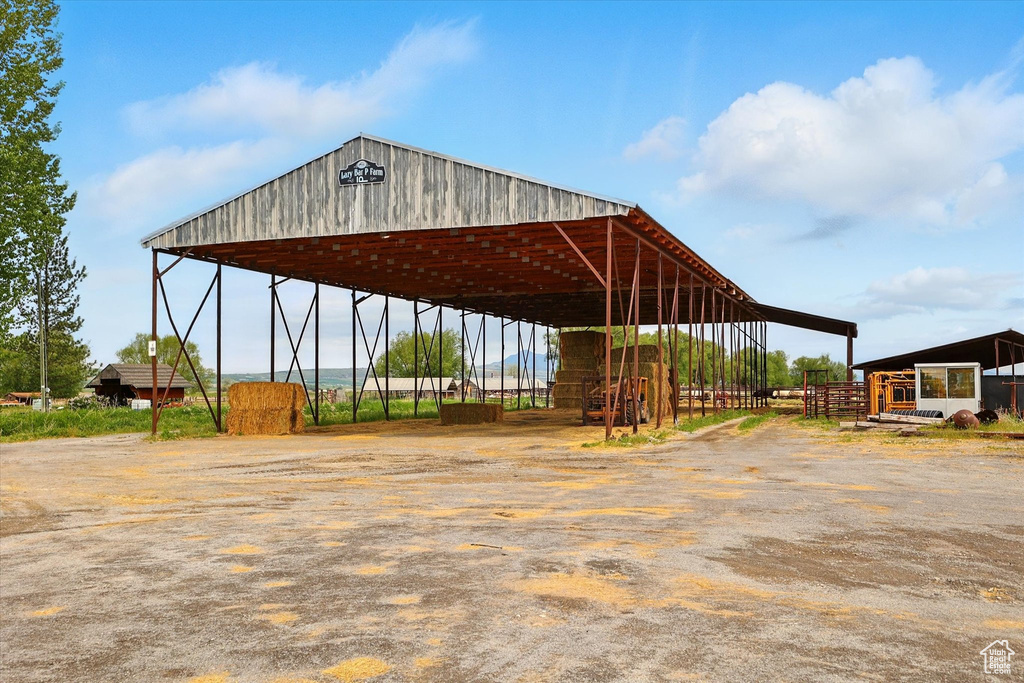 View of parking / parking lot with a carport