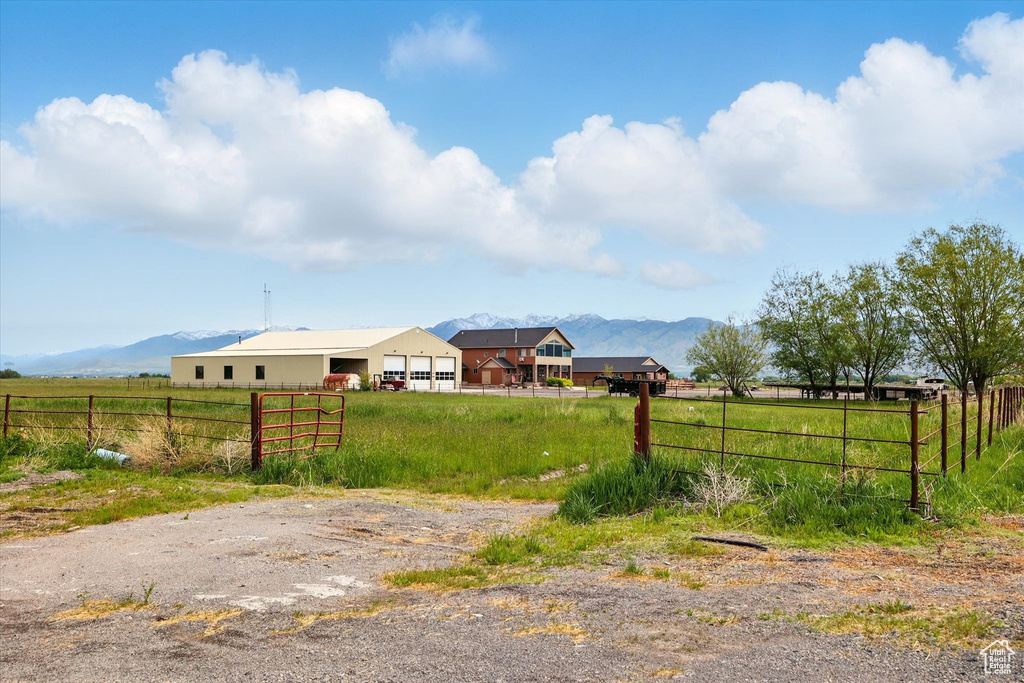 View of yard featuring fence, a rural view, and a mountain view