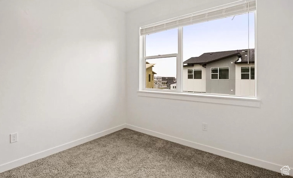 Unfurnished room with baseboards and carpet flooring