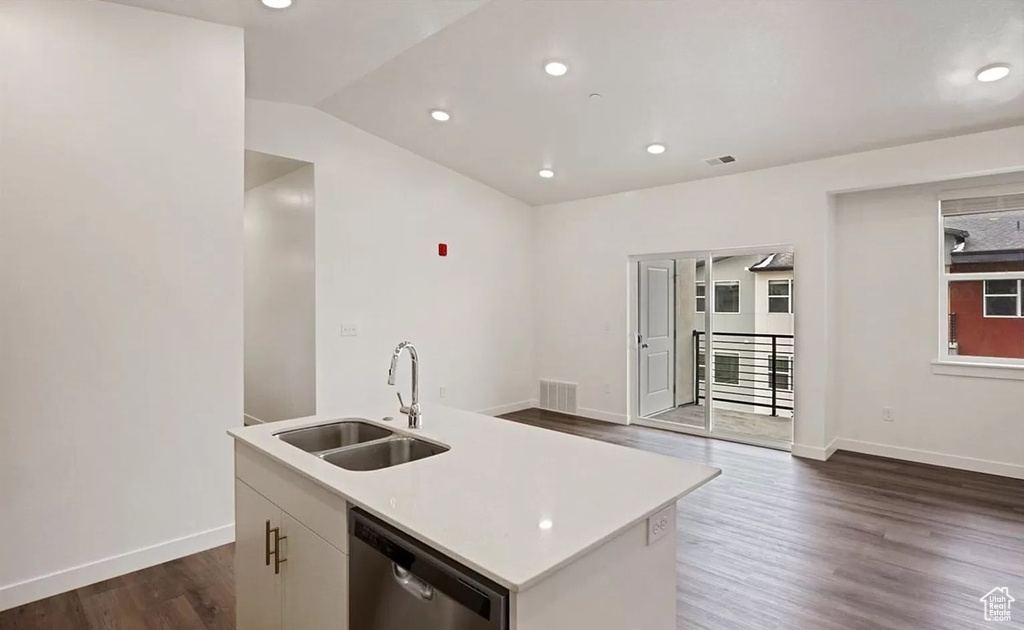 Kitchen featuring a sink, a kitchen island with sink, dishwasher, dark wood-style flooring, and visible vents