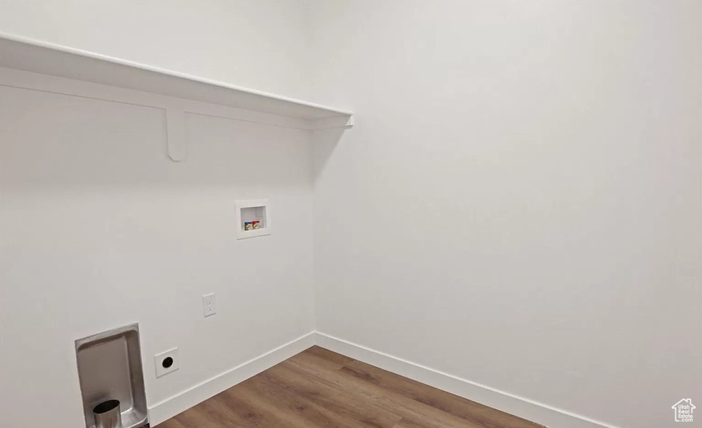 Washroom featuring hookup for an electric dryer, dark wood-style flooring, baseboards, hookup for a washing machine, and laundry area