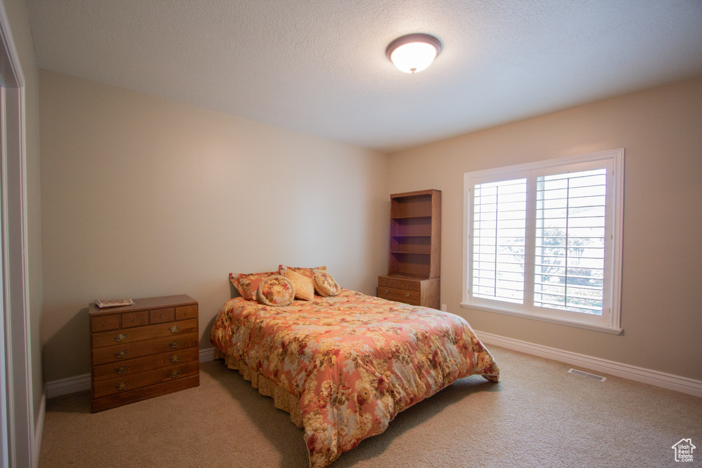 Carpeted bedroom featuring baseboards