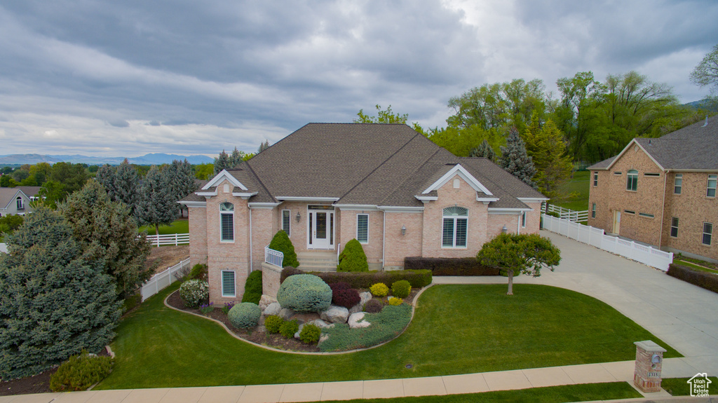 Traditional-style home featuring brick siding and concrete driveway