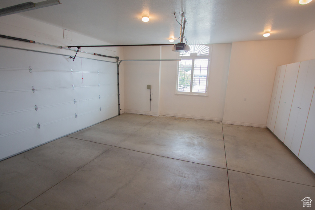 Garage featuring a garage door opener