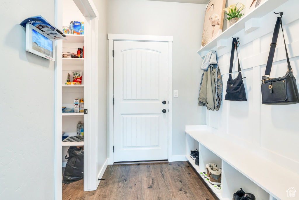 Mudroom with wood finished floors and baseboards