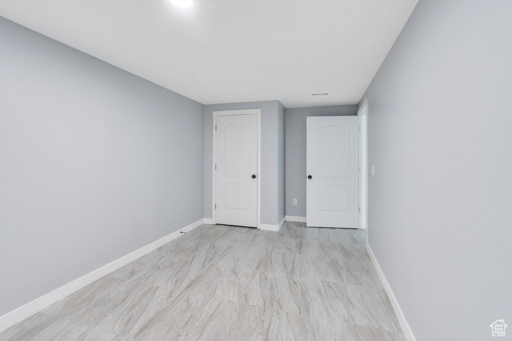 Spare room featuring baseboards