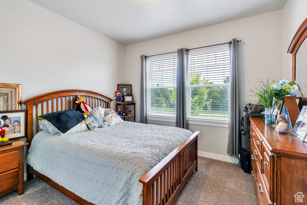 Carpeted bedroom featuring baseboards
