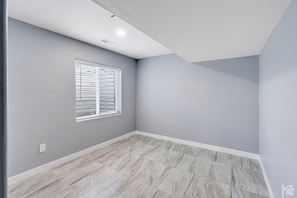Spare room featuring baseboards