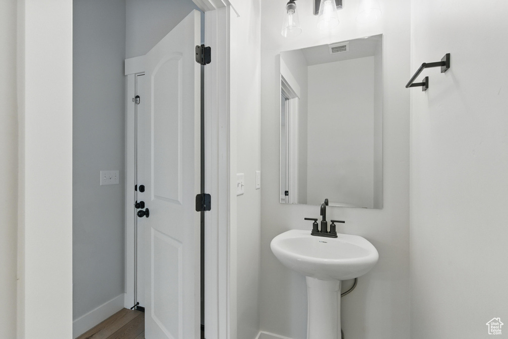 Bathroom with baseboards and wood finished floors