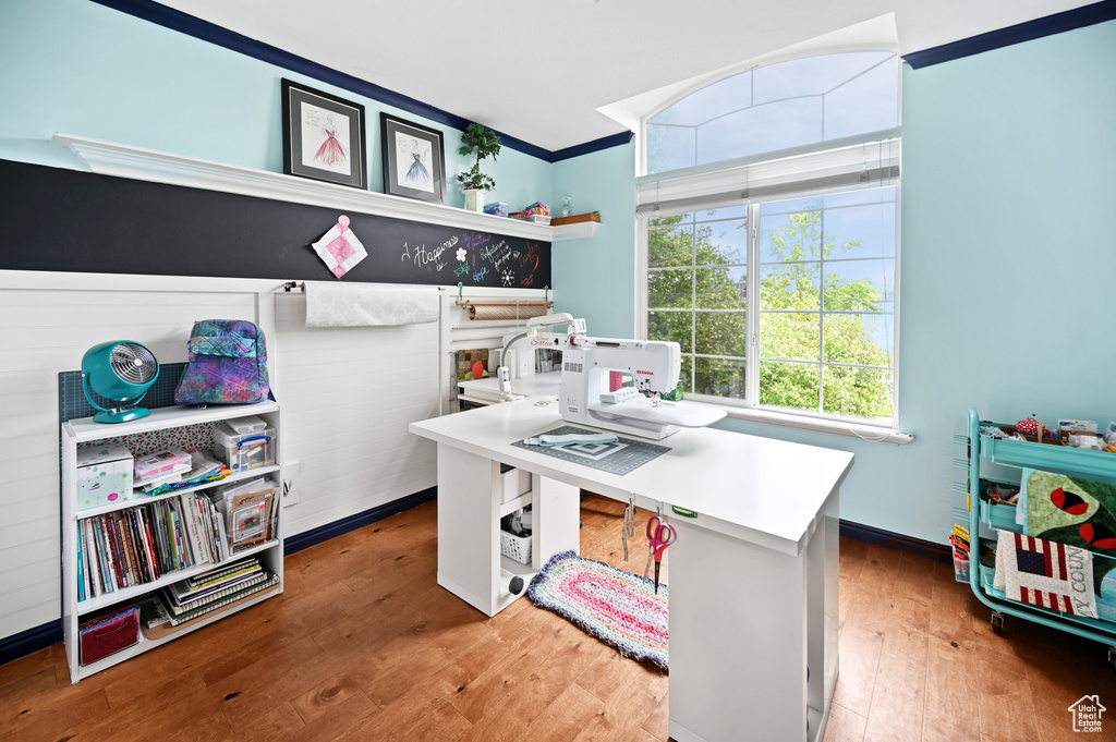 Office featuring hardwood / wood-style flooring and ornamental molding