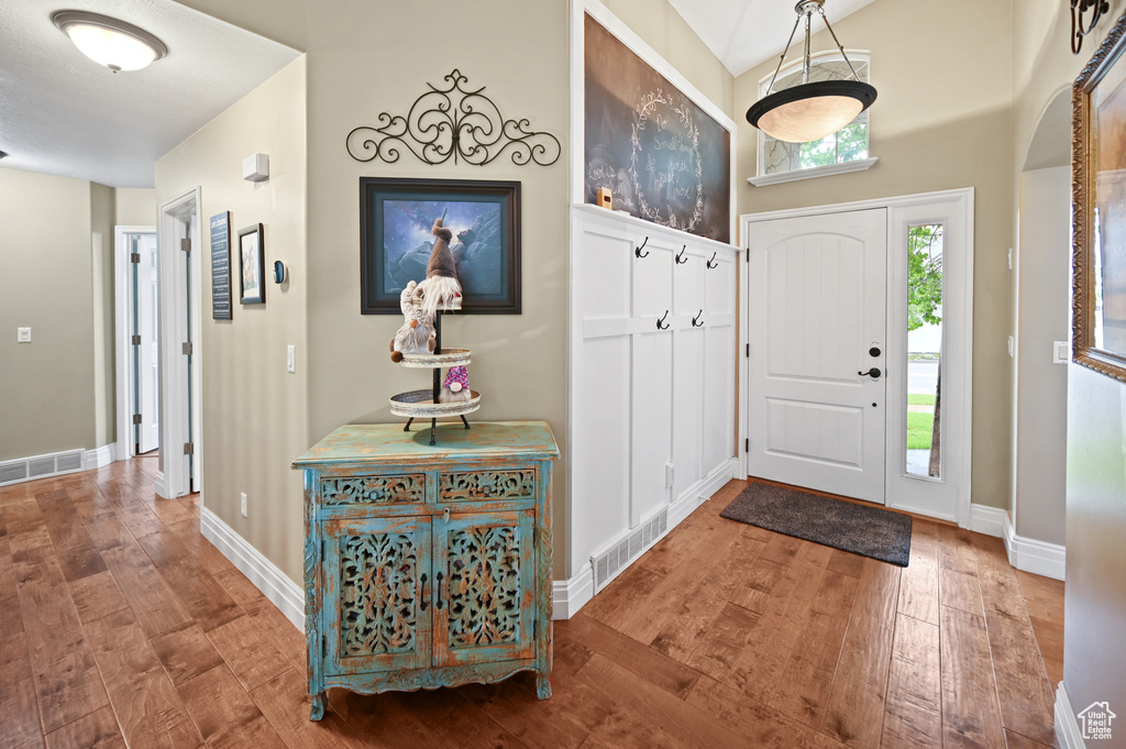 Entryway with wood finished floors and baseboards