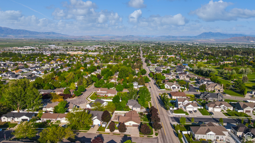 Aerial overview of property\'s location with a mountain backdrop and nearby suburban area