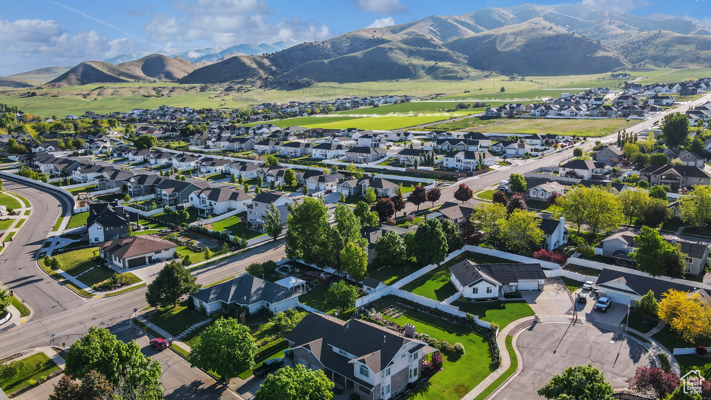 Aerial view of property\'s location featuring nearby suburban area and a mountain backdrop