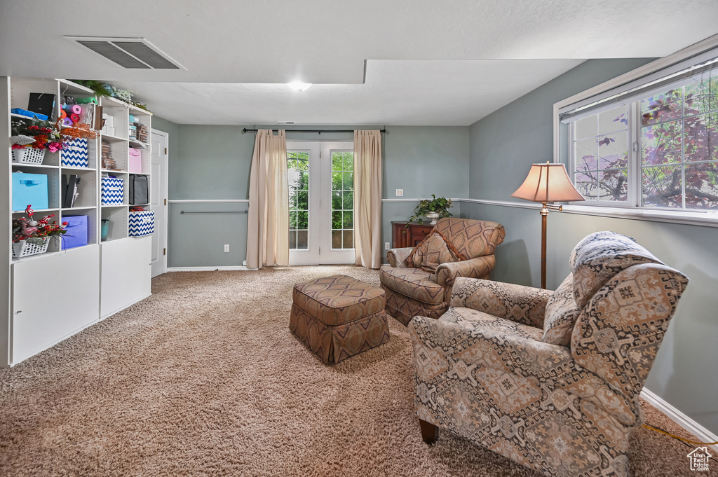 Living area with carpet flooring and baseboards