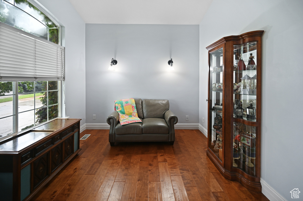 Sitting room with dark wood-type flooring and baseboards