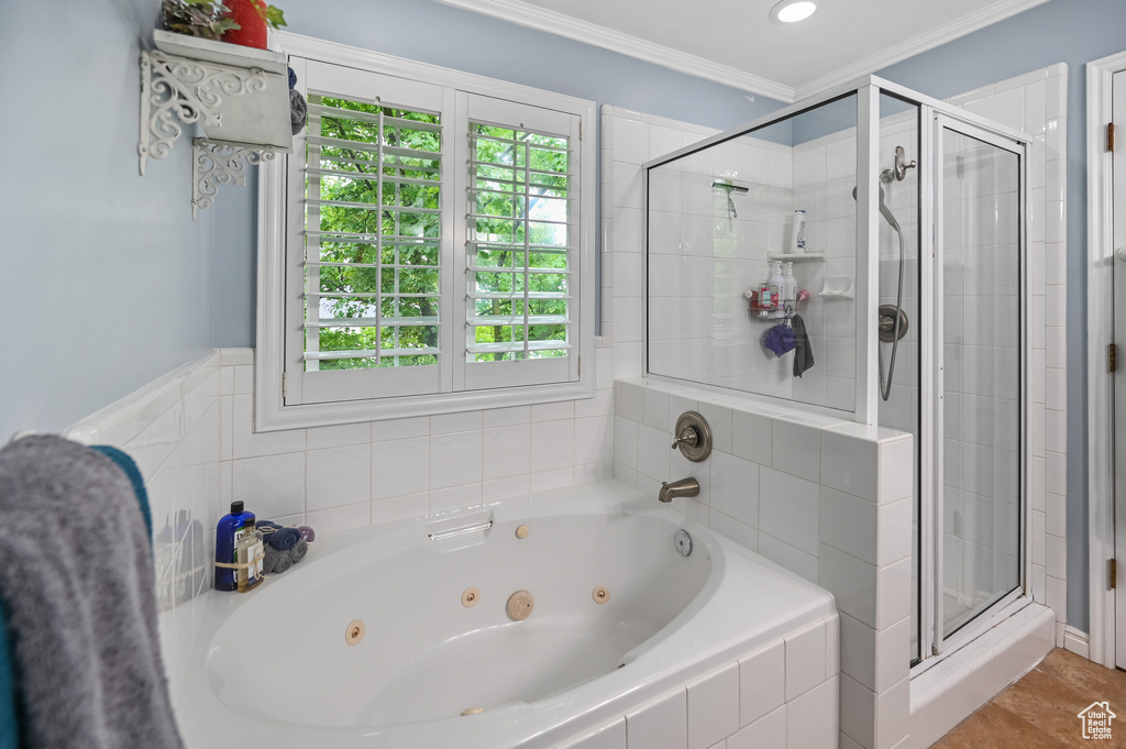 Full bath with a stall shower, a whirlpool tub, and crown molding
