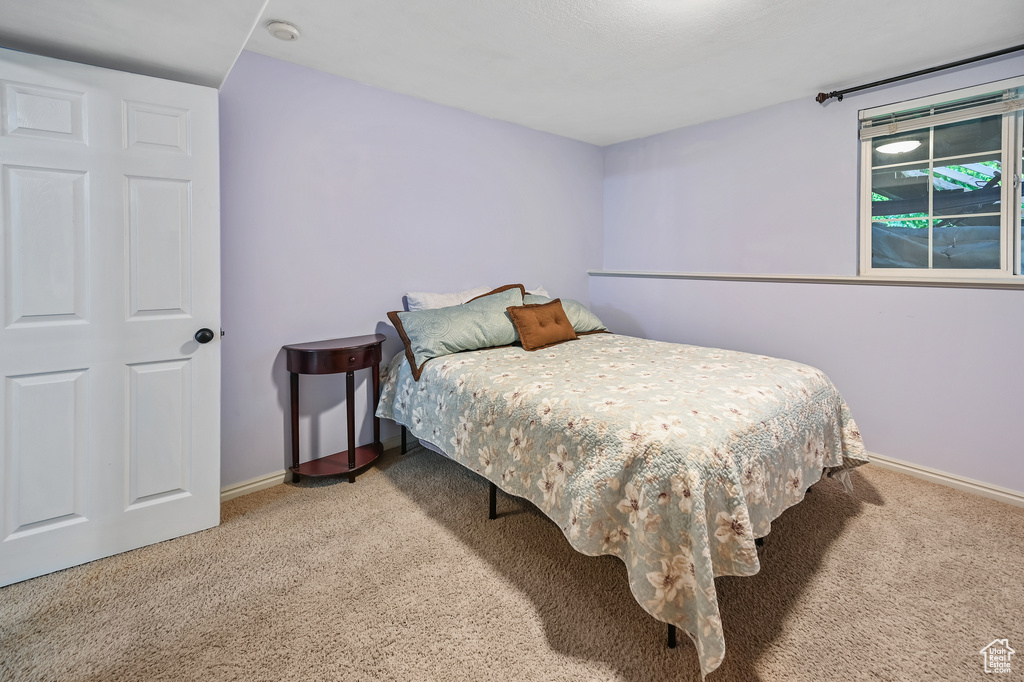 Bedroom featuring carpet flooring and baseboards