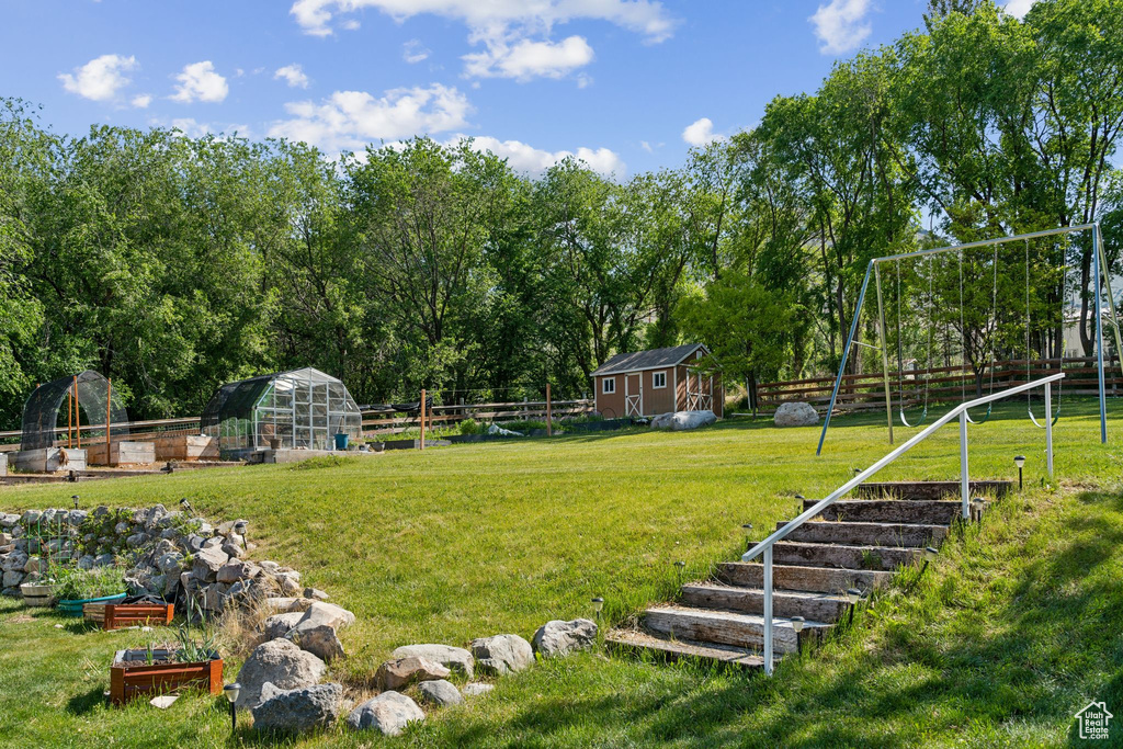 View of yard with an outdoor structure, an exterior structure, and a vegetable garden