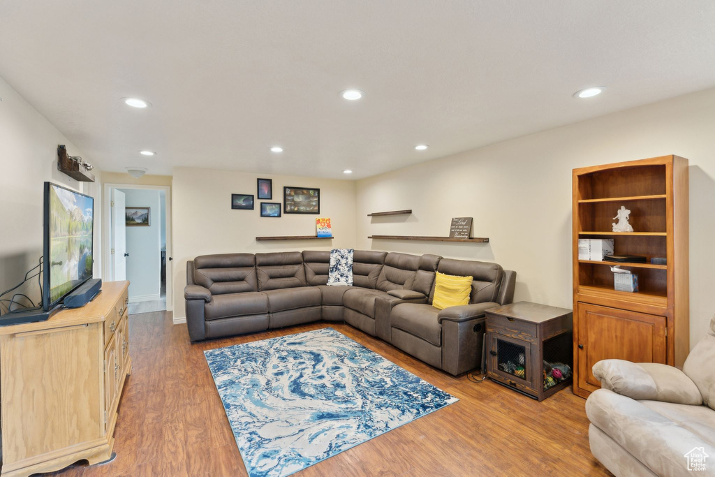 Living area with wood finished floors and recessed lighting