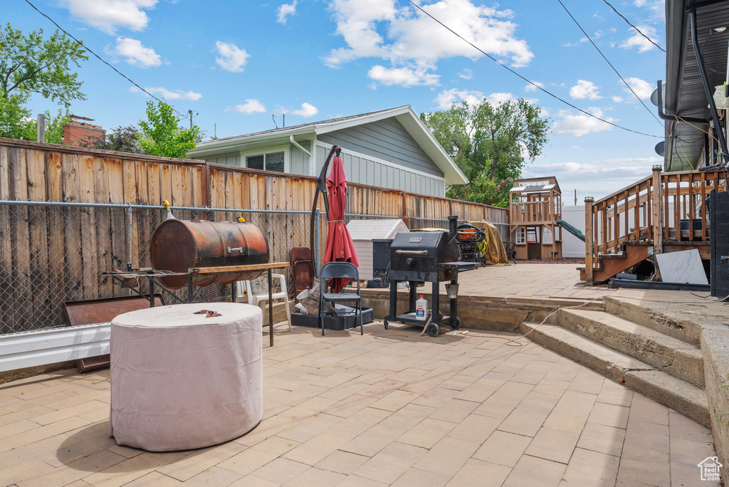 View of patio / terrace with a fenced backyard and a grill