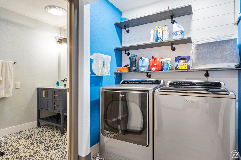 Laundry area with separate washer and dryer and baseboards