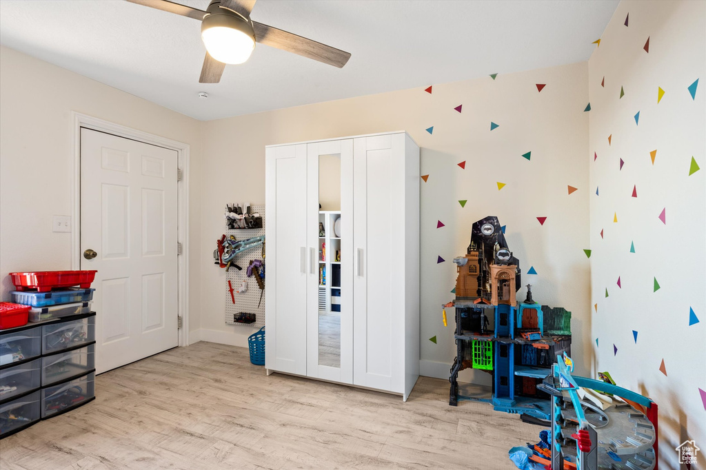 Game room with wood finished floors, a ceiling fan, and baseboards