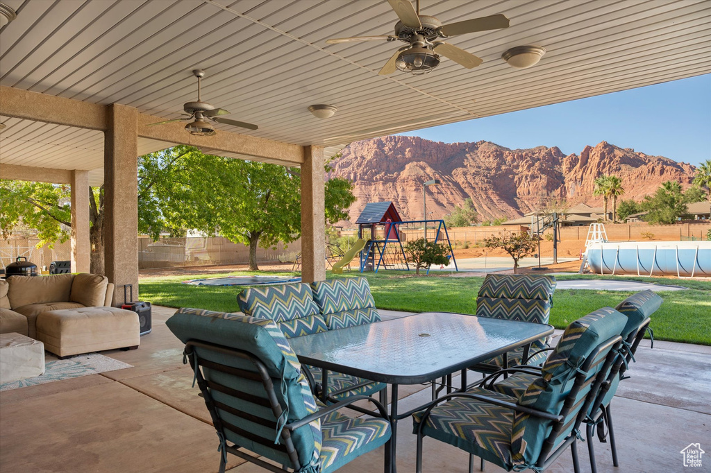 View of patio / terrace with outdoor dining space, a mountain view, ceiling fan, outdoor lounge area, and a playground