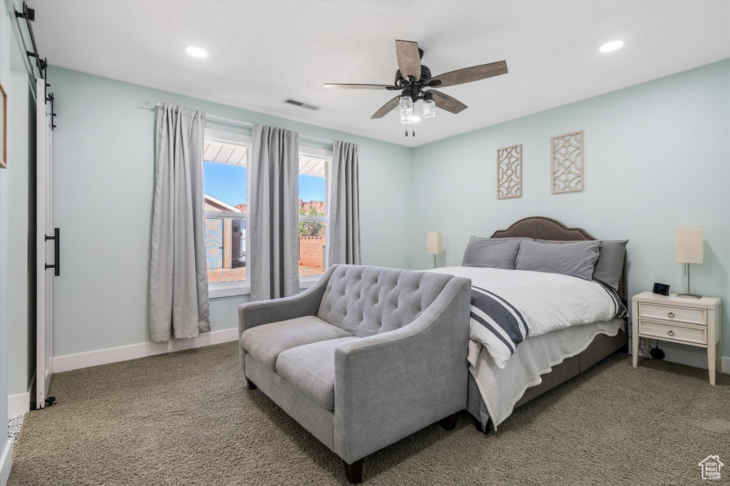 Bedroom with recessed lighting, a barn door, carpet flooring, baseboards, and a ceiling fan