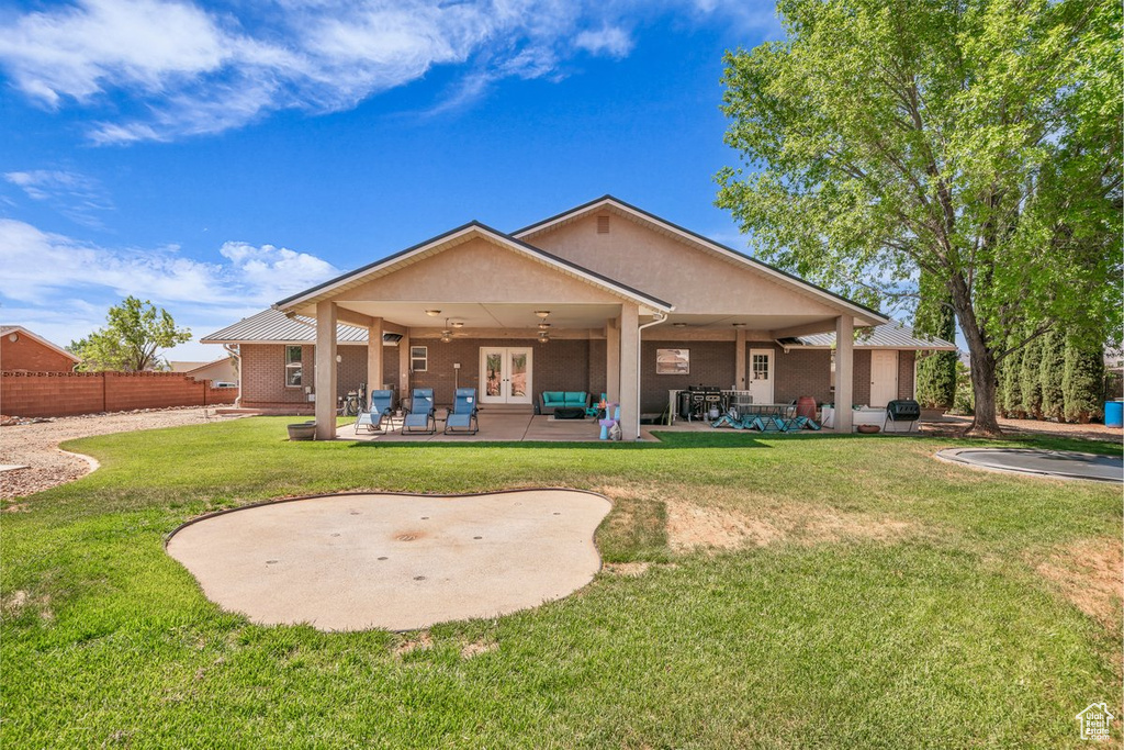 Rear view of property with ceiling fan, french doors, and a patio area