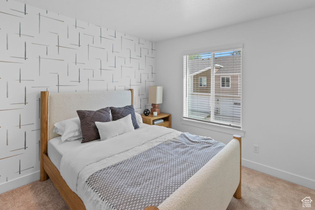 Bedroom with carpet floors and baseboards