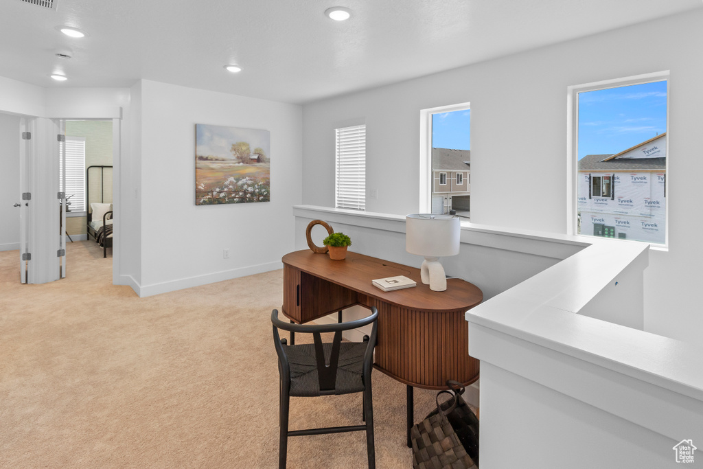 Office area featuring light colored carpet, baseboards, and recessed lighting
