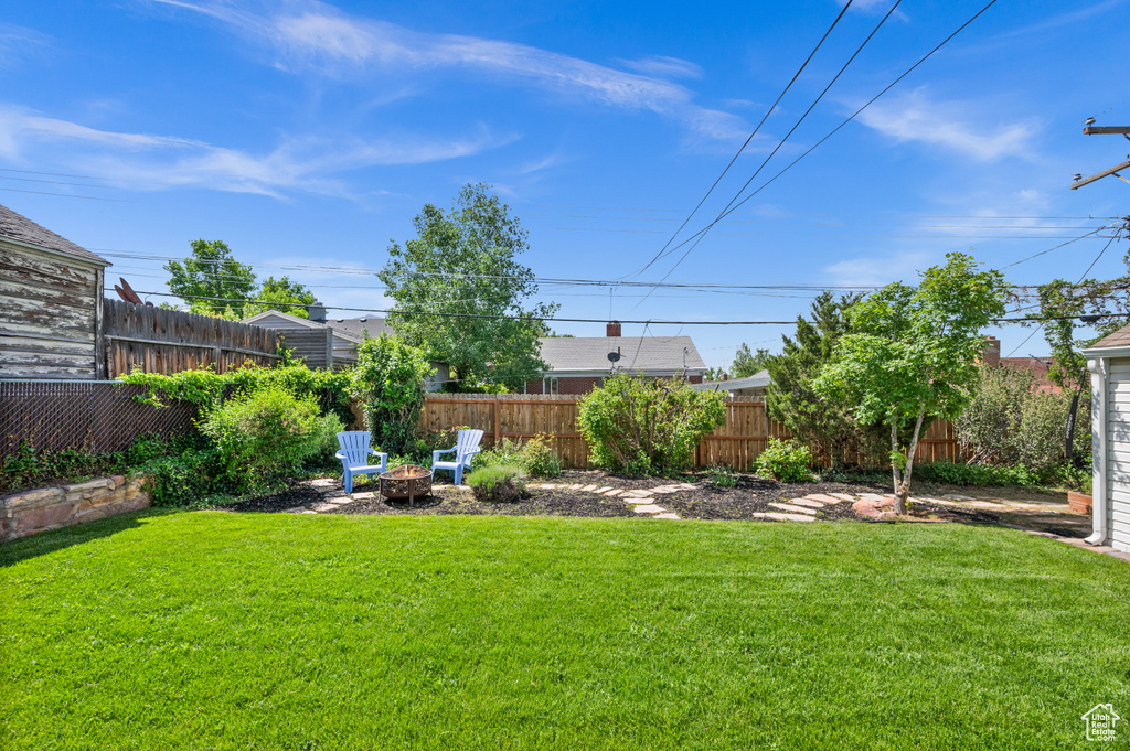 View of yard with an outdoor fire pit