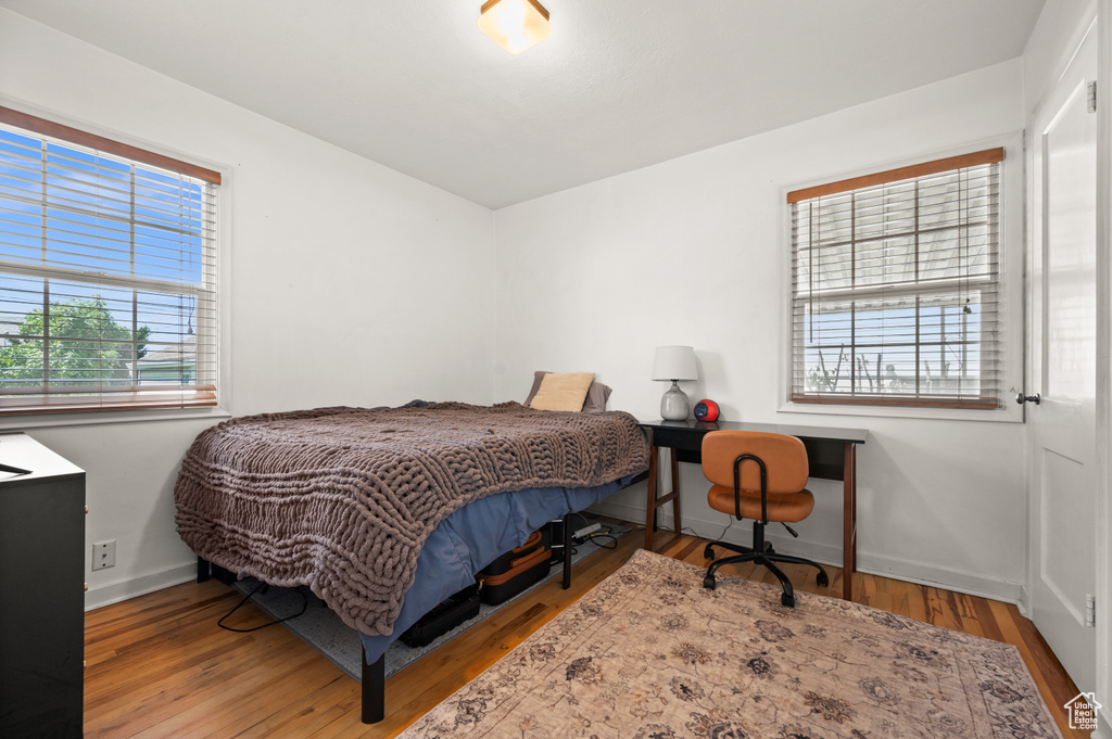 Bedroom featuring baseboards and wood finished floors