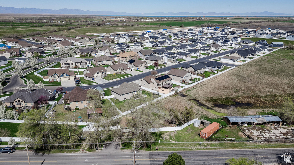 Aerial perspective of suburban area featuring a mountain backdrop