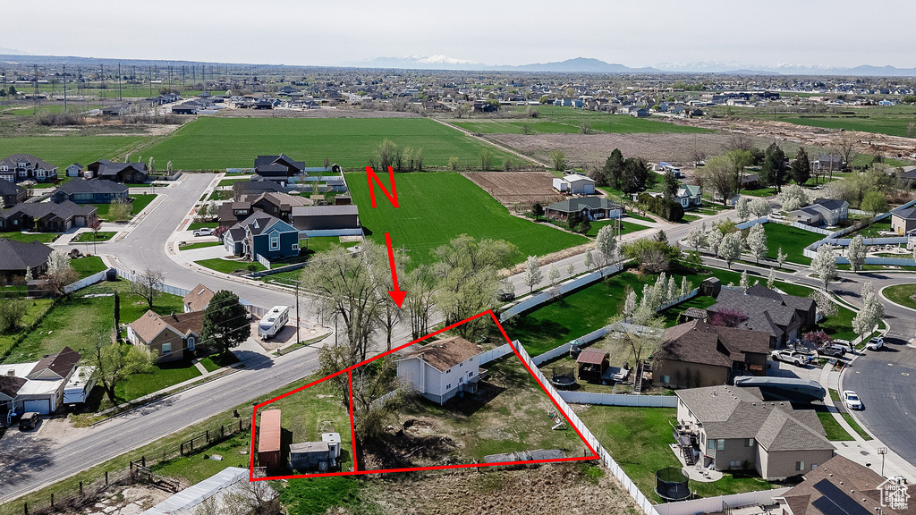 Aerial perspective of suburban area featuring property parcel outlined and mountains