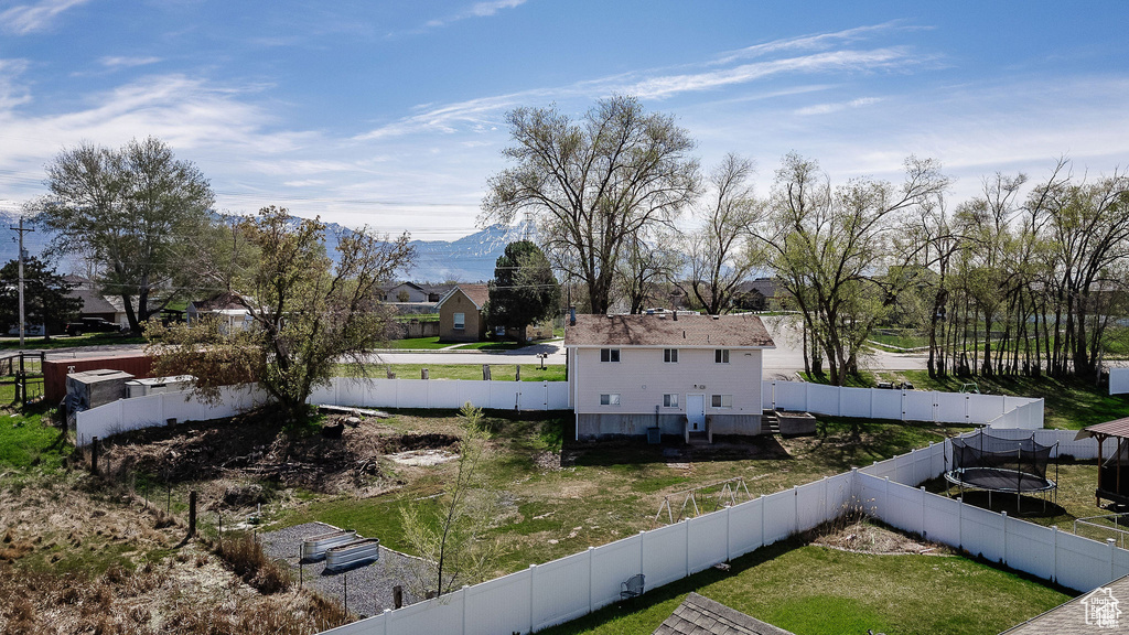 View of side of property featuring a trampoline and a mountain view