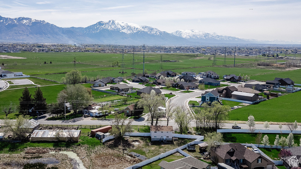 Overview of rural landscape featuring a mountainous background and nearby suburban area