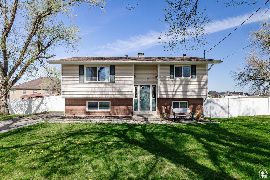 Raised ranch with entry steps and brick siding