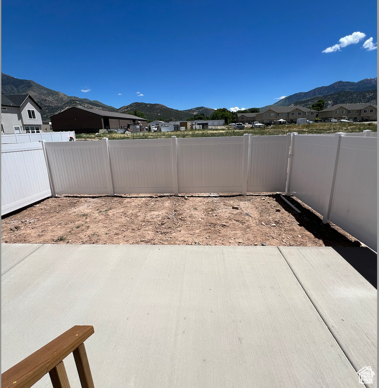 View of patio / terrace with a mountain view and a fenced backyard