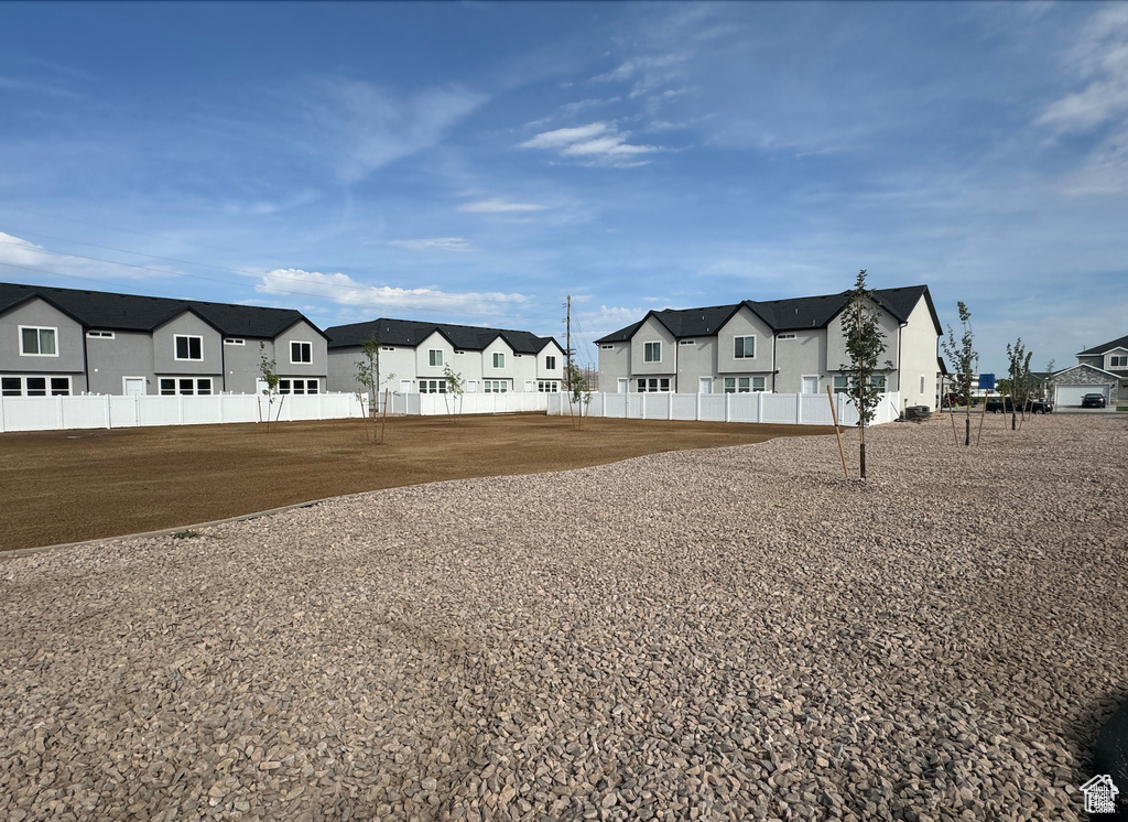 View of front of property featuring a residential view and fence