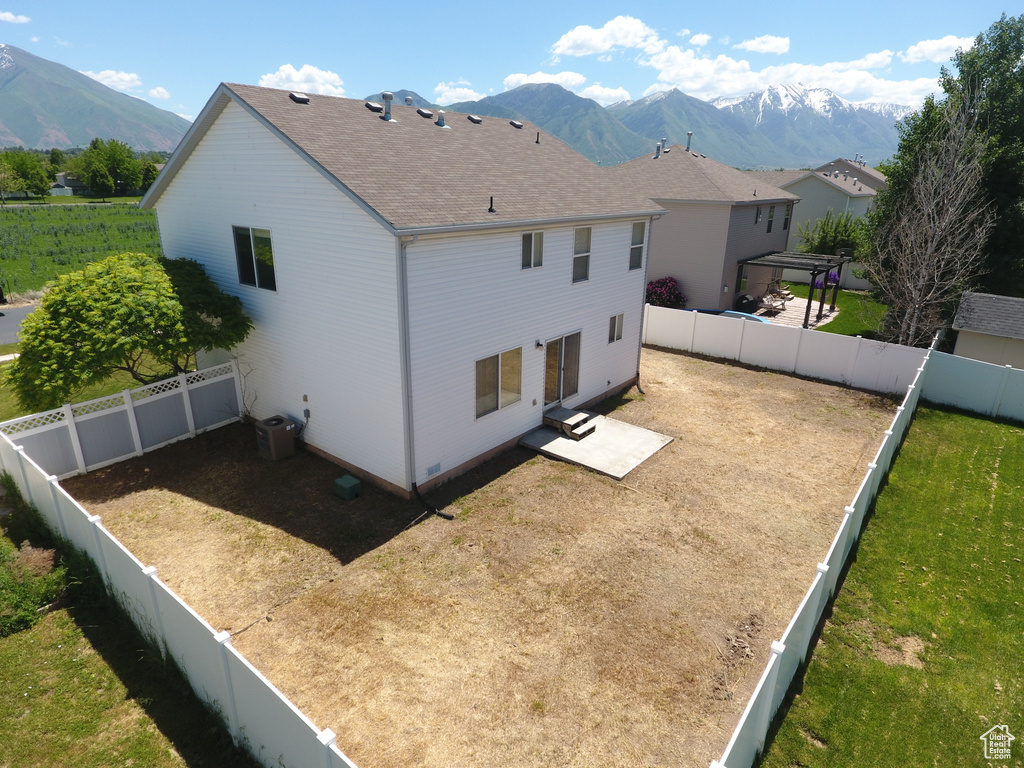 Rear view of house featuring a mountain view