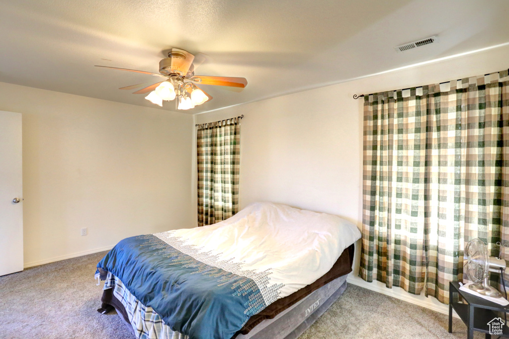 Bedroom with carpet and a ceiling fan