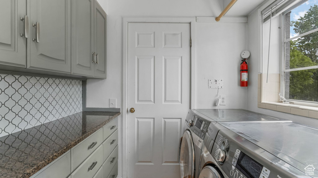 Laundry area with washer and clothes dryer and cabinet space