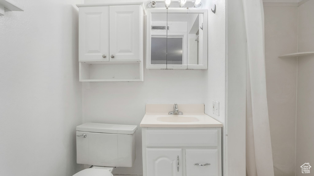 Bathroom featuring vanity and toilet