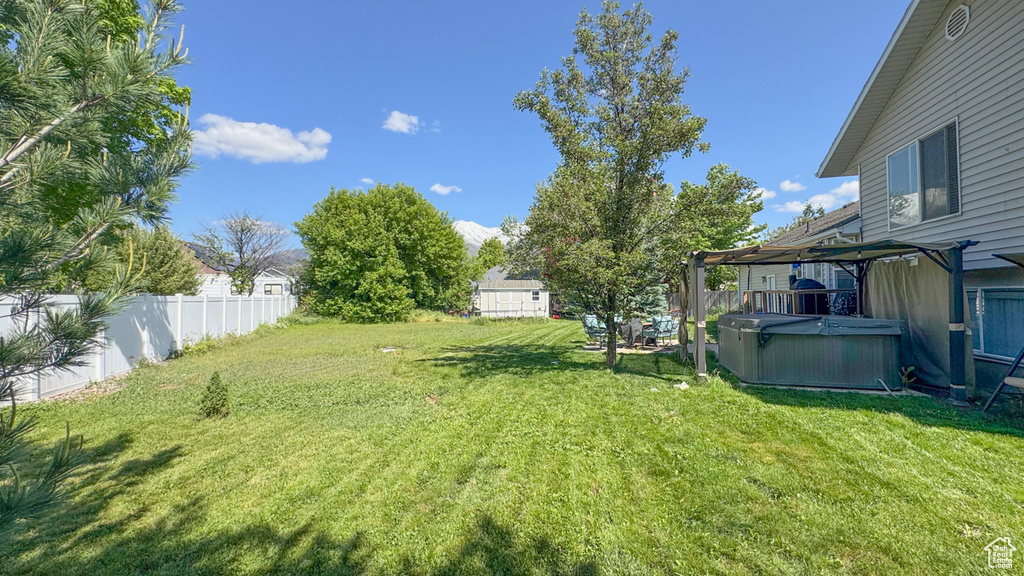 View of yard featuring a hot tub and a gazebo