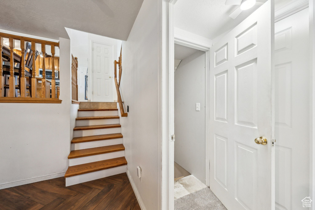Staircase featuring baseboards