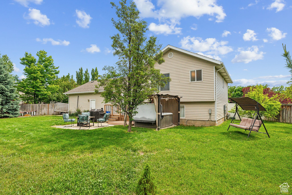 Back of house with a patio area