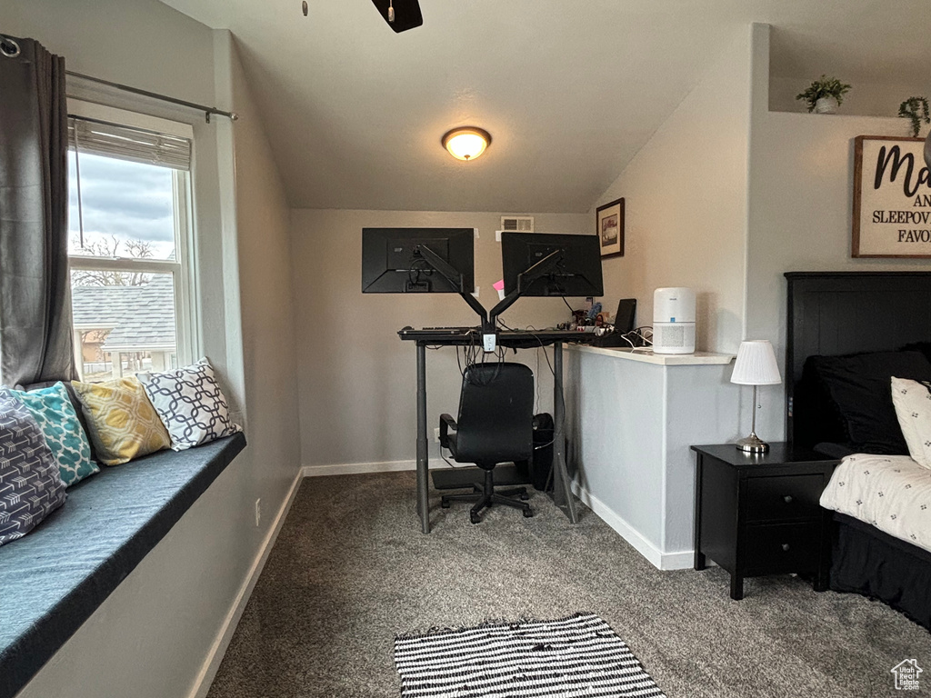 Office space with carpet floors, baseboards, and vaulted ceiling