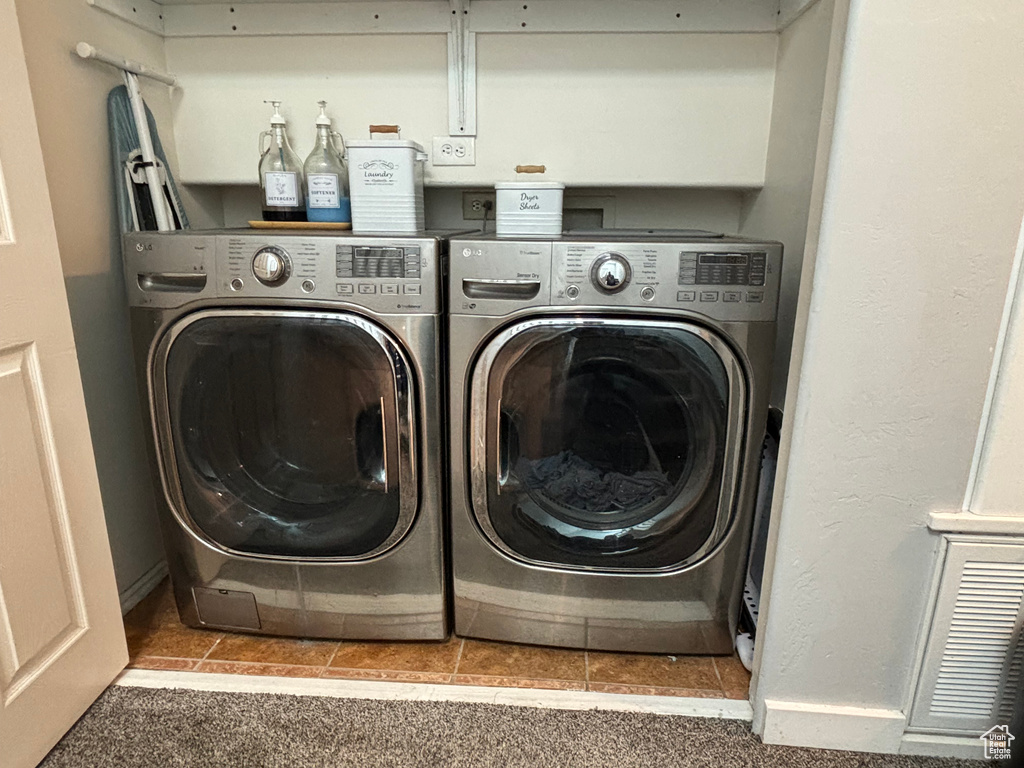 Laundry area featuring independent washer and dryer and tile patterned floors