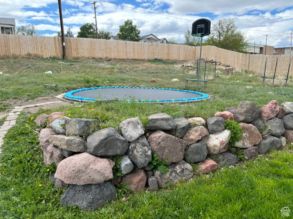 View of yard featuring fence